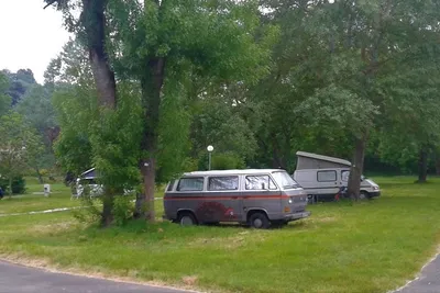 Camping Au Bord de Loire -  Wohnwagen- und Zeltstellplatz unter Bäumen auf dem Campingplatz