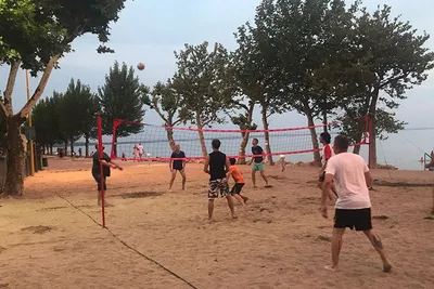 Camping Cisano - Gäste spielen auf dem Beachvolleyballfeld beim Campingplatz 