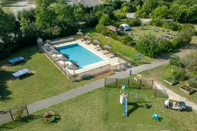 Camping du Plan d'Eau - Blick auf den Pool und den Kinderspielplatz