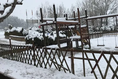 Camping Fuente de Regrustan - Spielplatz auf dem Campingplatz mit Rutsche und Schaukel im Winter