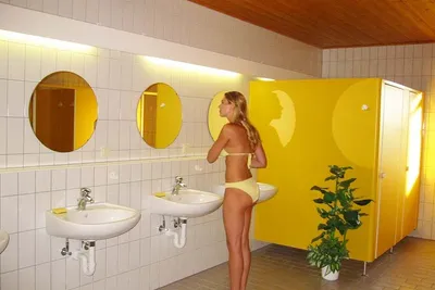 Camping Gößl - Innenraum des Sanitärgebäudes mit Toilettenkabinen, Waschbecken und Spiegeln