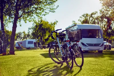 Camping Leśny (Nr. 51) - Wohnwagen- und Zeltstellplatz mit zwei geparkten Fahrrädern im Vordergrund