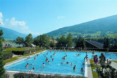 Camping Ramsbacher - Gäste liegen am Pool in der Sonne auf dem Campingplatz