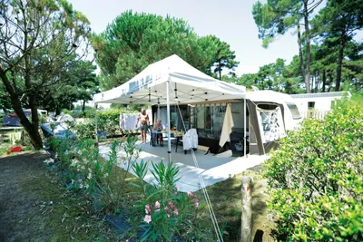 Camping St-Tro'Park  -  Wohnwagenstellplatz zwischen Bäumen auf dem Campingplatz