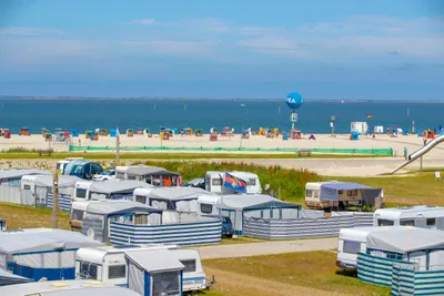 Camping am Nordseestrand - Gäste am Badestrand vor dem Campingplatz mit Stellplätzen